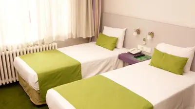two beds in a hotel room with green and white at Mini Harem Hotel in Istanbul