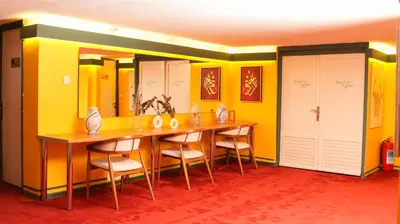 a dining room with yellow walls and a table and chairs at Mini Harem Hotel in Istanbul