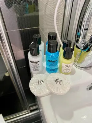 a bathroom sink with four bottles of disinfectants on it at Honey Hotel in Istanbul
