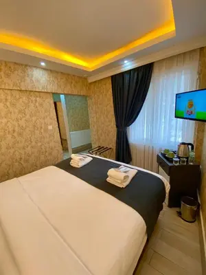 a bedroom with a large bed with a flat screen tv at Honey Hotel in Istanbul