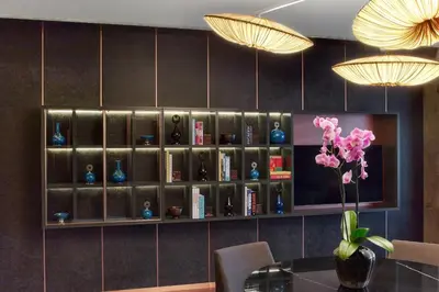 a book shelf with a bunch of vases on it at The St. Regis Istanbul in Istanbul