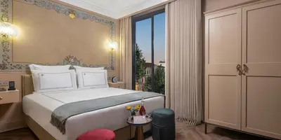 a bedroom with a bed and a large window at Komana Hotel Binbirdirek in Istanbul