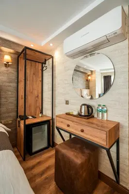 a bedroom with a vanity and a mirror and a bed at Old Harbour Hotel istanbul in Istanbul