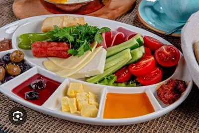 a tray of food with vegetables and cheese on a table at Old Harbour Hotel istanbul in Istanbul
