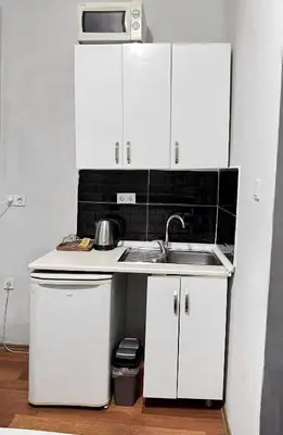 a white kitchen with a sink and a microwave at Taksim Plaza Suite in Istanbul