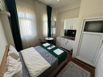 a small room with a bed and a kitchen at Taksim Plaza Suite in Istanbul