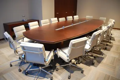 a conference room with a large wooden table and chairs at Hotel Suadiye in Istanbul