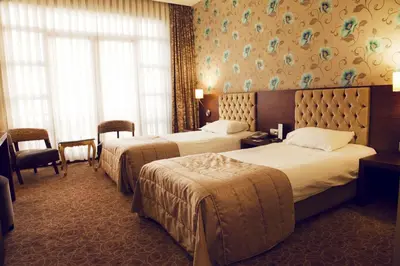a hotel room with two beds and a window at Hotel Suadiye in Istanbul