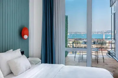 a bedroom with a bed and a balcony with a view at Stay Beyond the Bosphorus #5 in Istanbul