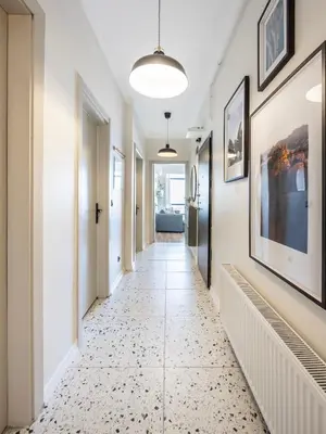 a hallway with a tile floor and a hallway with paintings at Stay Beyond the Bosphorus #5 in Istanbul