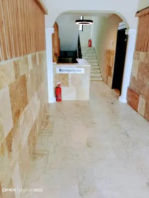 an empty hallway with a tile floor and stairs at Bayramoğlu Suite in Darıca