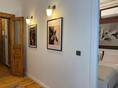 a room with three pictures on a wall with a bed at Historic High-Ceiling 2-Flat Combo - Taksim in Istanbul