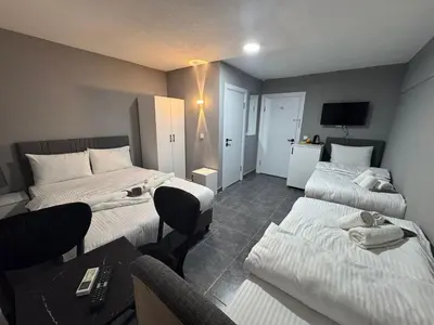 a hotel room with two beds and a desk at Old City Kadıköy Otel in Istanbul