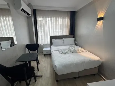 a hotel room with a bed and a table and chairs at Old City Kadıköy Otel in Istanbul