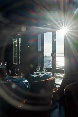 a restaurant with two tables and chairs with a view of the ocean at Vakko Hotel Sumahan Bosphorus in Istanbul