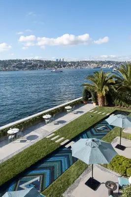 a view of the water with tables and umbrellas at Vakko Hotel Sumahan Bosphorus in Istanbul