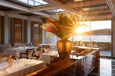 a restaurant with tables and a vase with a plant at Vakko Hotel Sumahan Bosphorus in Istanbul