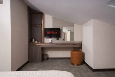 a room with a desk in the corner of a room at Byon Hotel Şile in Sile