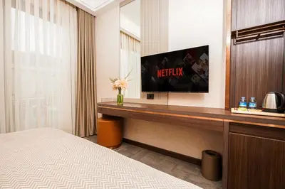 a hotel room with a bed and a television at Byon Hotel Şile in Sile