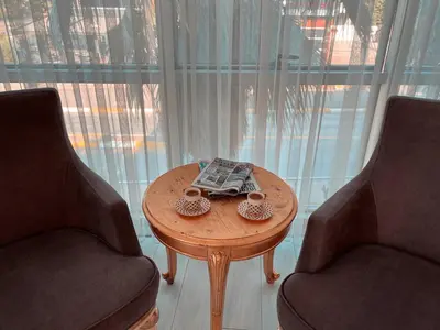 a table with two chairs and a book on it at Ottoman Hotel Sakarya in Sakarya