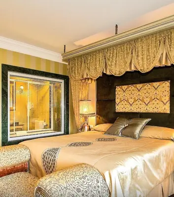 a bedroom with a large bed with a large window at Anemon Bursa Gönlüferah Termal&Spa Otel in Bursa