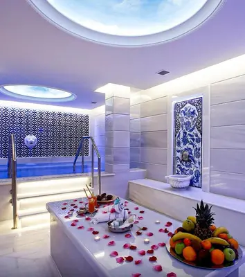 a bathroom with a tub and a table with fruit on it at Anemon Bursa Gönlüferah Termal&Spa Otel in Bursa