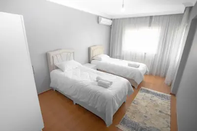 a room with two beds and a window at New furniture, zero air conditioning, modern and quiet 19 in Istanbul