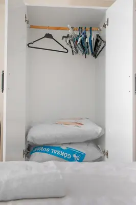 a room with a pile of pillows and a shelf at New furniture, zero air conditioning, modern and quiet 19 in Istanbul