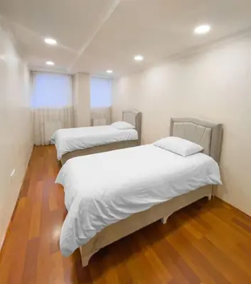 three beds in a room with wood floors at Ground floor apartment in a quiet area 17 in Istanbul
