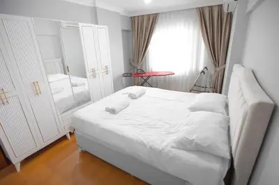 a small bedroom with a white bed and a window at Large central apartment in a quiet area 40 in Istanbul