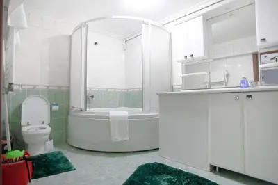 a bathroom with a tub and a toilet and a sink at Large central apartment in a quiet area 40 in Istanbul