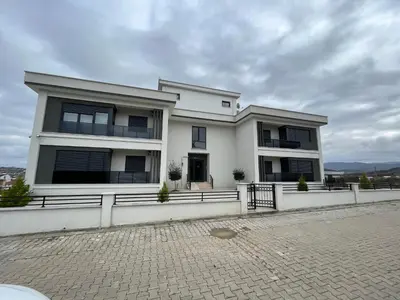 a large white building with a fence in front of it at Yalova Cozy Home in Yalova
