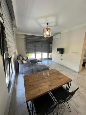 a living room with a wooden table and a couch at Yalova Cozy Home in Yalova