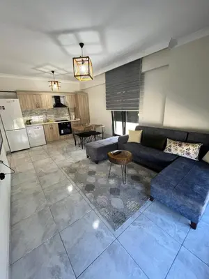 a living room with a couch and a table at Yalova Cozy Home in Yalova