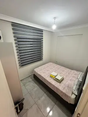 a bedroom with a bed with two books on it at Yalova Cozy Home in Yalova