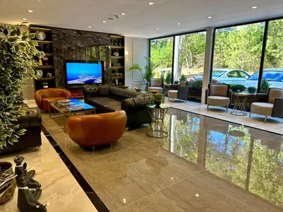 a living room filled with furniture and a flat screen tv at Kerpe Bungalov Hotel in Kandıra