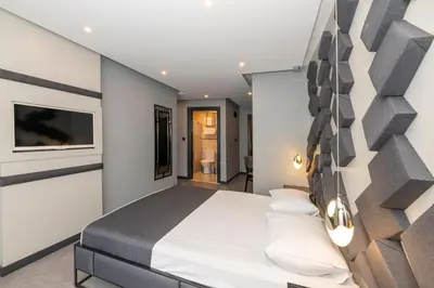 a bedroom with a large bed and a wall at White Palace Hotel in Istanbul