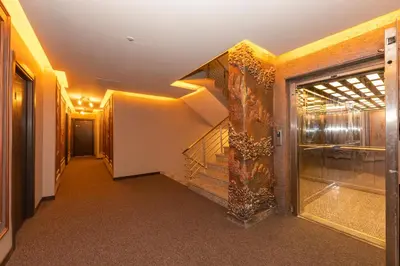 a hallway of a building with stairs and a window at White Palace Hotel in Istanbul