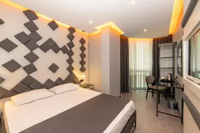 a bedroom with a bed and a desk in a room at White Palace Hotel in Istanbul