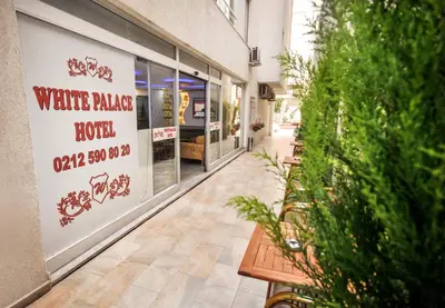 a shop with a sign on the side of a building at White Palace Hotel in Istanbul