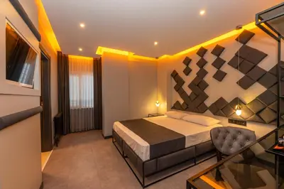 a bedroom with a bed and a chair in a room at White Palace Hotel in Istanbul