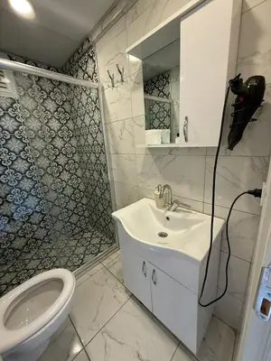 a white bathroom with a sink and a toilet at AYD Apart Elmadağ Taksim in Istanbul