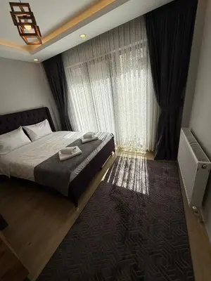 a bedroom with a bed and a large window at AYD Apart Elmadağ Taksim in Istanbul