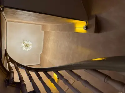 a spiral staircase with a light at the top at Mansion Istanbulite in Istanbul