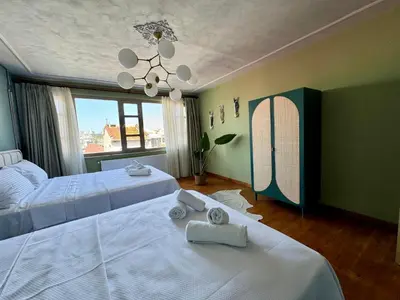 a bedroom with two beds and a chandelier at Mansion Istanbulite in Istanbul