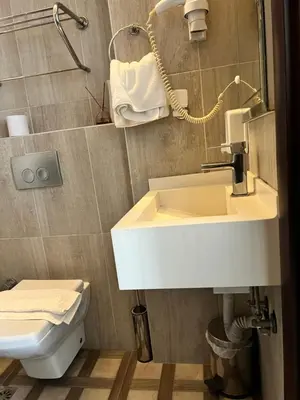 a bathroom with a white sink and a toilet at Nacre Boutique Residence in Istanbul