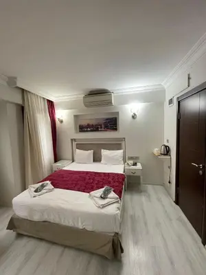 a bedroom with a large bed with a red blanket at Nacre Boutique Residence in Istanbul