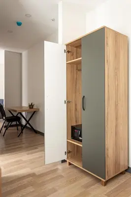 a room with a sliding door and a table at Atm Suit Otel in Istanbul