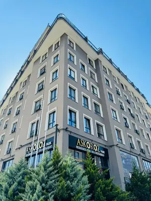 an apartment building with trees in front of it at Askoroz Otel İzmit in Izmit