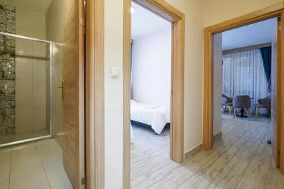 a room with a glass door leading to a bedroom at Askoroz Otel İzmit in Izmit